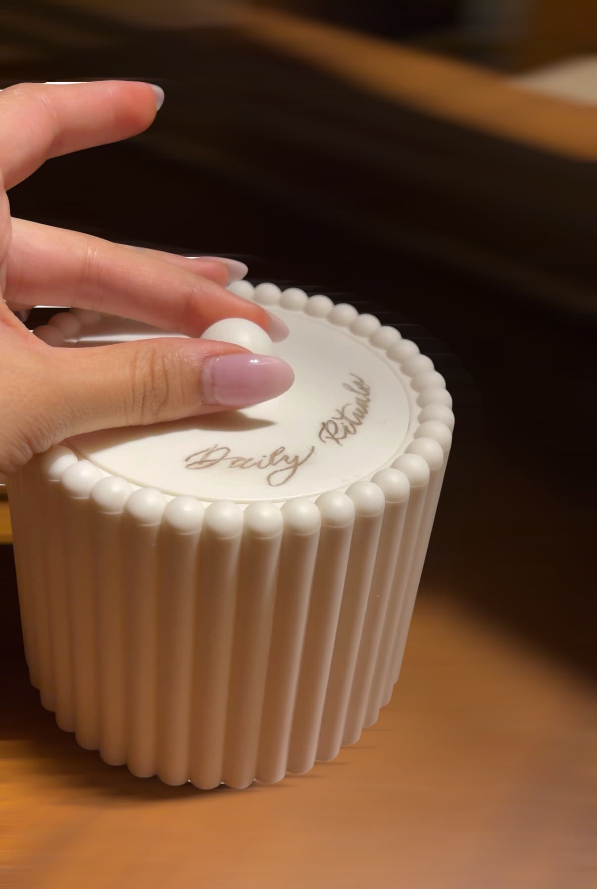 Personalized lettering on a white ribbed candle vessel